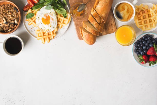 istock Fried egg, spinach, waffles and cup of coffee espresso, bread, baguette, muesli on white background 1219706563