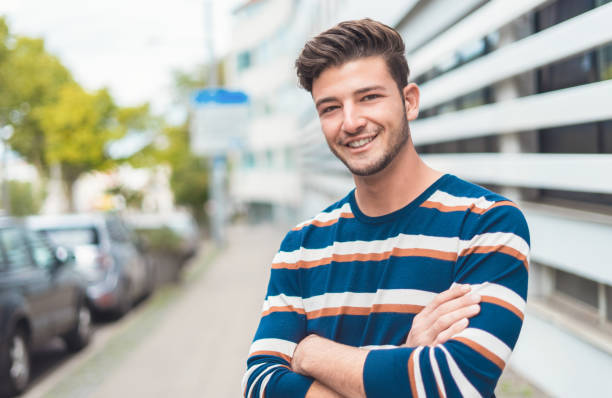 istock Waist up happy young man smiling to camera 1219706621