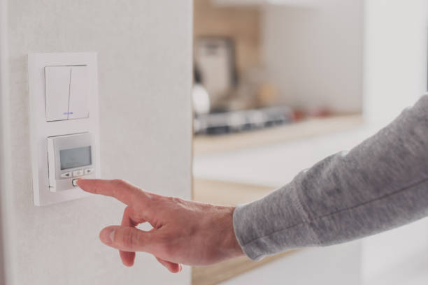 istock Men hand setting the temperature on control panel of DHW or central heating. 1219707917