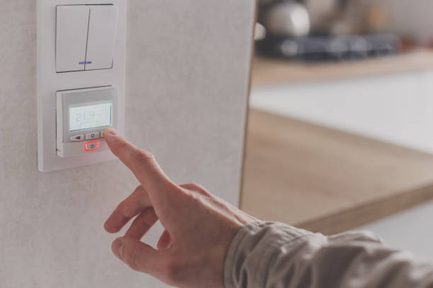 istock Men hand setting the temperature on control panel of DHW or central heating. 1219707930