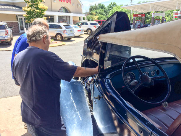 1934 Ford Roadster convertible rumble seat classic automobile Philadelphia, PA, USA - July, 7, 2019, 1934 Ford Roadster blue at gas station with men talking 1934 stock pictures, royalty-free photos & images