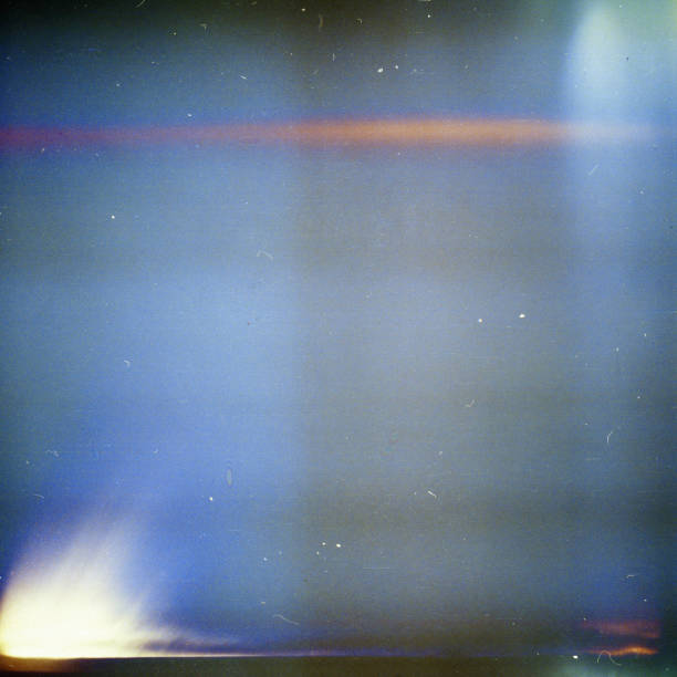istock Noisy blue film frame with scratches, dust and light leak 1219713534