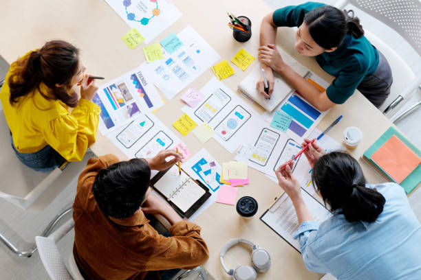istock Brainstorm planing creative asian teamwork,  Group of asia mobile phone app developer team meeting for share ideas about screen display prototype layout for smartphone, ui, ux startup small business, top view 1219714126