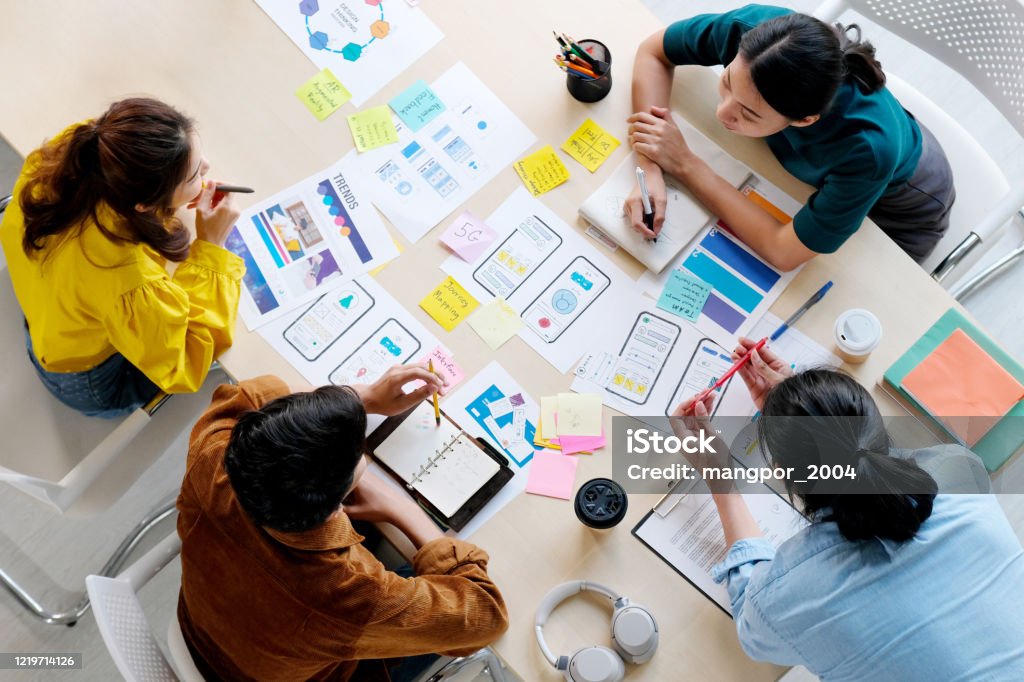 Brainstorm planing creative asian teamwork,  Group of asia mobile phone app developer team meeting for share ideas about screen display prototype layout for smartphone, ui, ux startup small business, top view Design Stock Photo