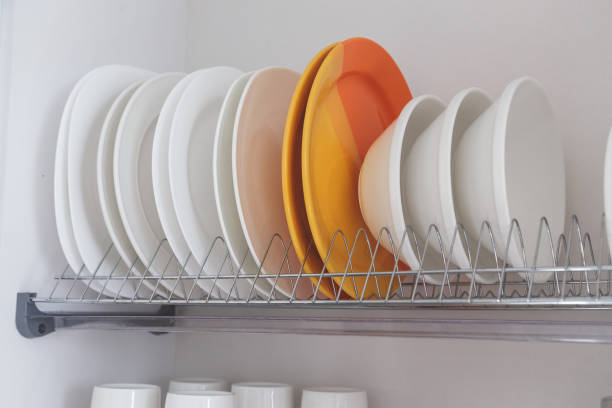 istock Dish drying metal rack with big nice white clean kitchenware. Traditional wall cabinet kitchen 1219714785