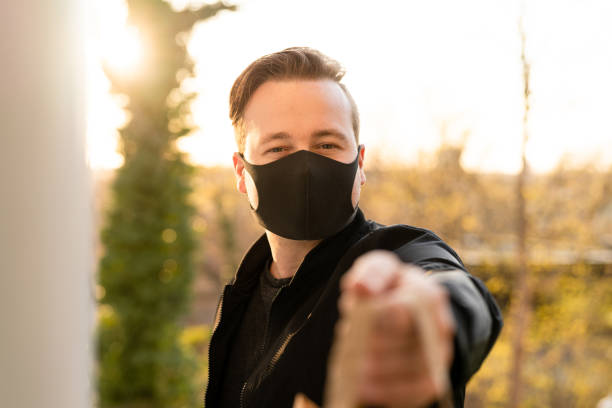 istock Man with face mask delivering food 1219715146