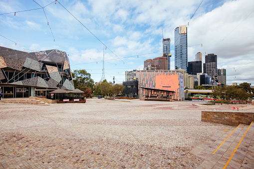Melbourne, Australia - April 18 2020: Melbourne's iconic Federation Square is oddly quiet and empty during the Coronavirus pandemic and associated lockdown.