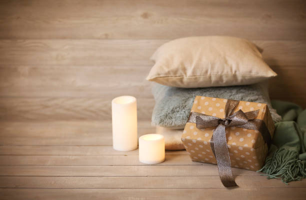 comfortable cushions, candles and present in cozy living room - christmas quilt blanket green imagens e fotografias de stock