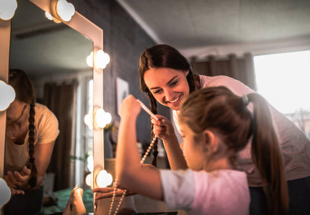 istock Mother and daughter applying makeup 1219718936