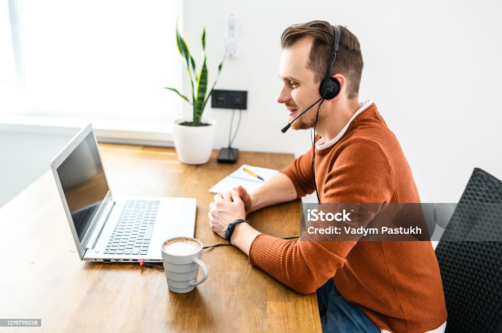 https://media.istockphoto.com/id/1219719038/photo/the-guy-uses-hands-free-headsets-to-work-from-home.jpg?s=1024x1024&w=is&k=20&c=4VPOdhrJeV5_W0Qh_kcgLH8g3aFEaeAdIb9lWGFRj8w=