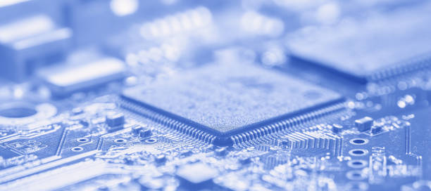 istock Microchip and printed circuit board in soft focus. The photo toned blue. 1219720267