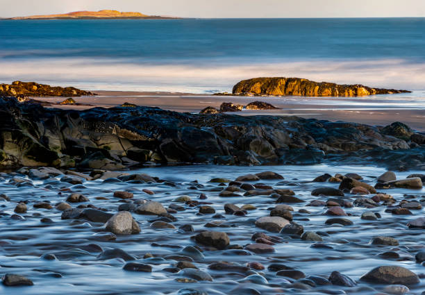 Atlantic ocean smoothed by long exposure at sunset.