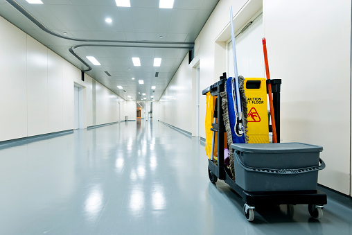 Cleaning cart in hospital corridor.