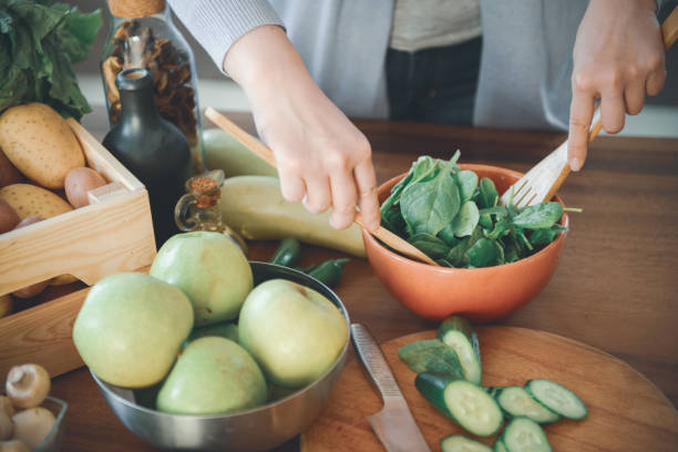 istock woman in the kitchen preparing food 1219726581