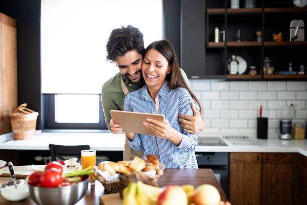 istock Beautiful couple in the kitchen while cooking. 1219727718