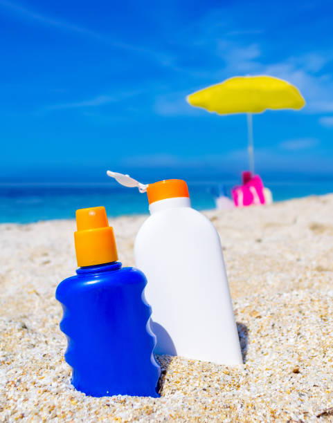 istock Blue and white suntan bottles on a white beach 1219727766