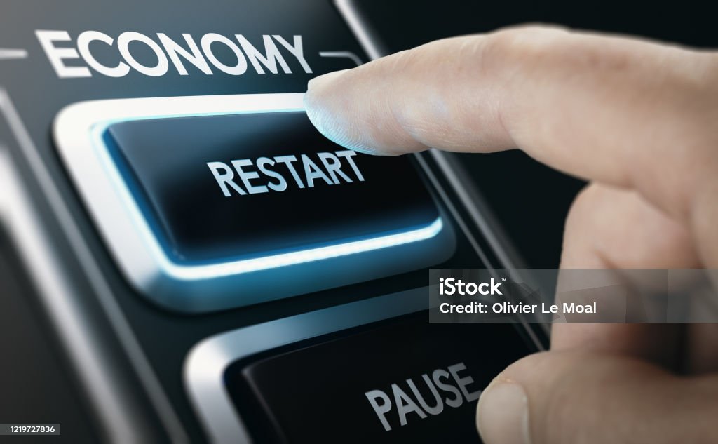 Disaster recovery. Restarting national economies after crisis. Man pressing a button to restart national economy after crisis. Composite image between a hand photography and a 3D background. Economy Stock Photo