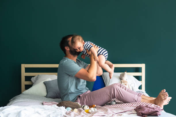istock Morning Cuddles: Father and his Baby Boy Enjoying a Weekend Morning 1219729094