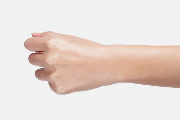 istock a moist, slender hand with a fist. 1219729137