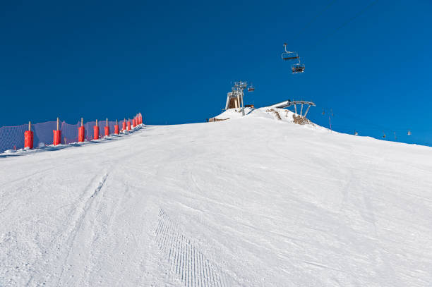 istock View up a piste in alpine ski resort 1219729245