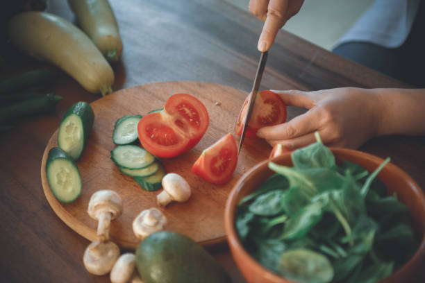 istock woman in the kitchen preparing food 1219730029