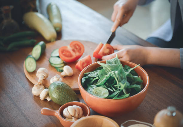 istock woman in the kitchen preparing food 1219730109
