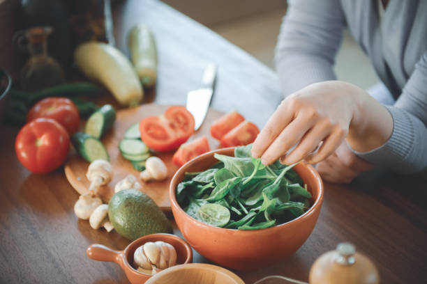 istock woman in the kitchen preparing food 1219730219