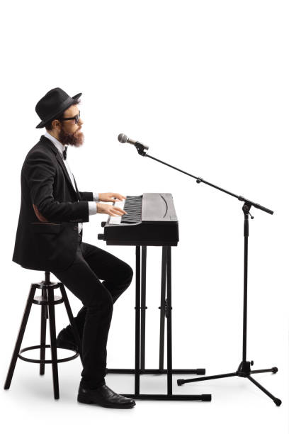 istock Artist playing a digital piano and singing on a microphone 1219730625