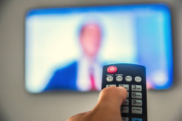 istock Man watching tv in a hotel room 1219730688