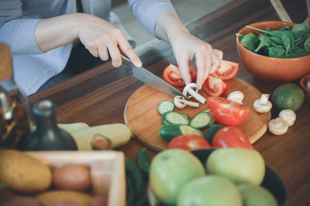 istock woman in the kitchen preparing food 1219731327