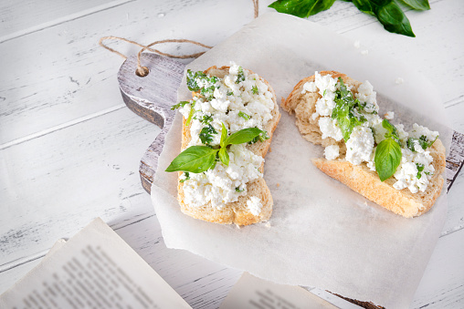 sandwiches with soft cheese and herbs on a white wooden background, Basil, Breakfast, book  , top view, copy space