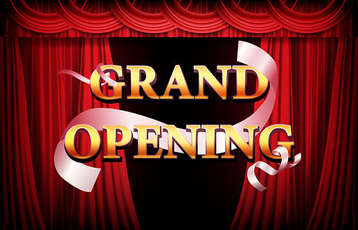 abstract background of golden grand opening banner with red curtain and ribbon