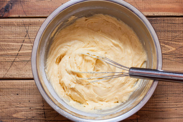 istock Step-by-step preparation of vanilla muffins, step 4 - adding flour, top view, horizontal 1219731529