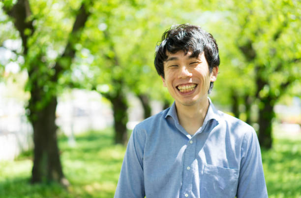 istock Portrait of Asian man standing in a park surrounded by verdure 1219731663