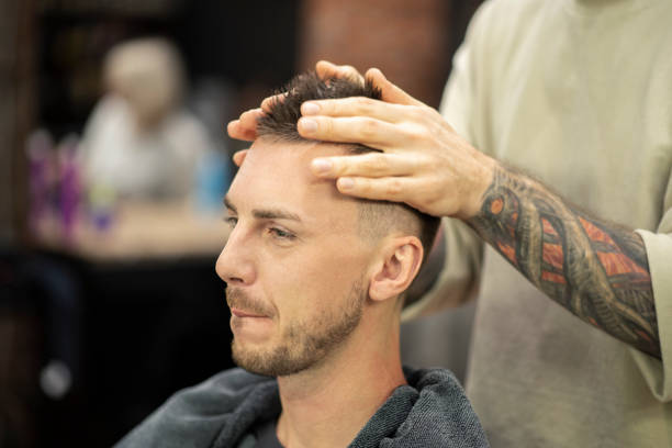 istock Barber preparing a client for haircut at barber shop 1219731944