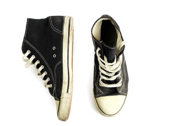 istock Old grunge sneakers isolated on white 1219732175