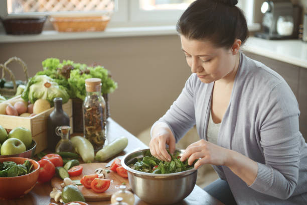 istock woman in the kitchen preparing food 1219734599