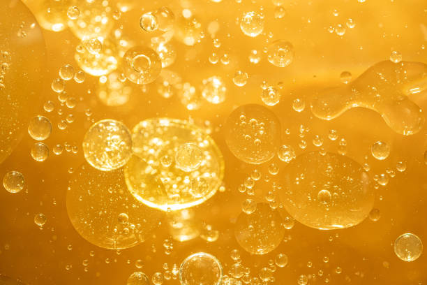 istock golden yellow bubble oil droplet, abstract background 1219735754
