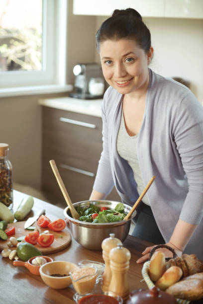 istock woman in the kitchen preparing food 1219736819