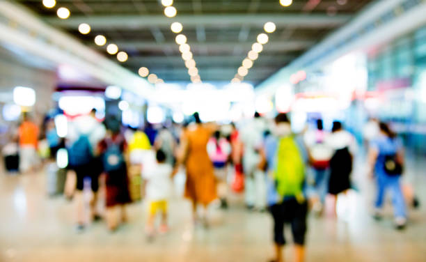 istock Group of people walking in airport 1219738647