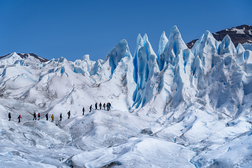 Los Glaciares National Park, Argentina - December 10, 2019: Tourists trekking on Perito Moreno Glacier in Los Glaciares National Park near El Calafate in Argentina, Patagonia, South America.