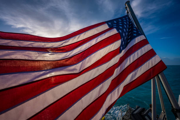 istock American Flag Backlit with Early Morning Sun 1219742325