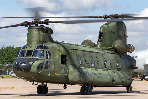 RAF Waddington, Lincolnshire, UK - July 7, 2014: Royal Netherlands Air Force Boeing CH-47D Chinook twin engined heavy lift military helicopter D-101 taxis for departure from RAF Waddington in Lincolnshire.