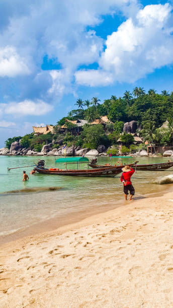 Sairee beach, Koh Tao, Thailand In January 2016, a longtail boat taxi driver was waiting for tourists on Sairee beach, Koh Tao, Thailand koh tao thailand stock pictures, royalty-free photos & images