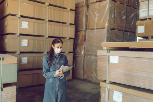 istock Woman working in industry distribution warehouse 1219747222