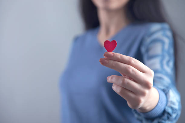 istock woman hand red heart 1219748003