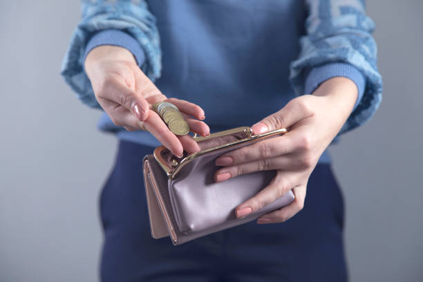 istock woman hand wallet with coins 1219748018
