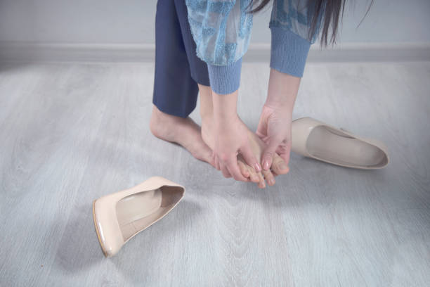 istock woman Feet hurt shoes 1219748040