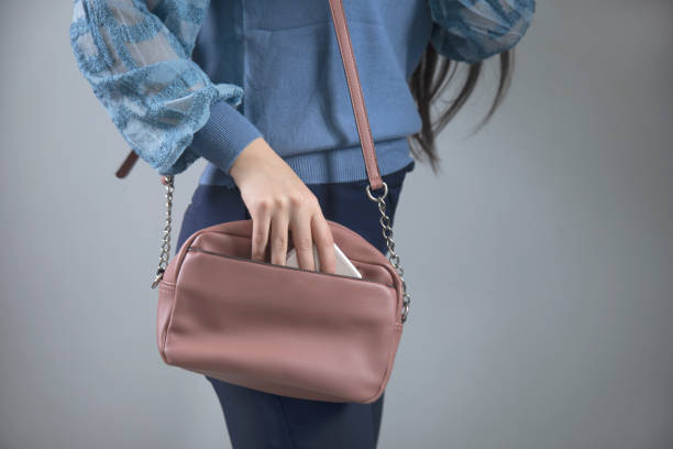 istock woman hand bag with phone 1219748102