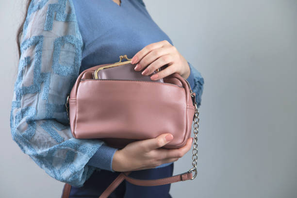 istock woman hand pink bag with wallet 1219748106